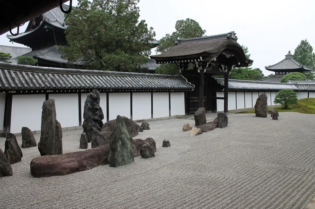 Zen garden with large rocks in front of Japanese traditional building