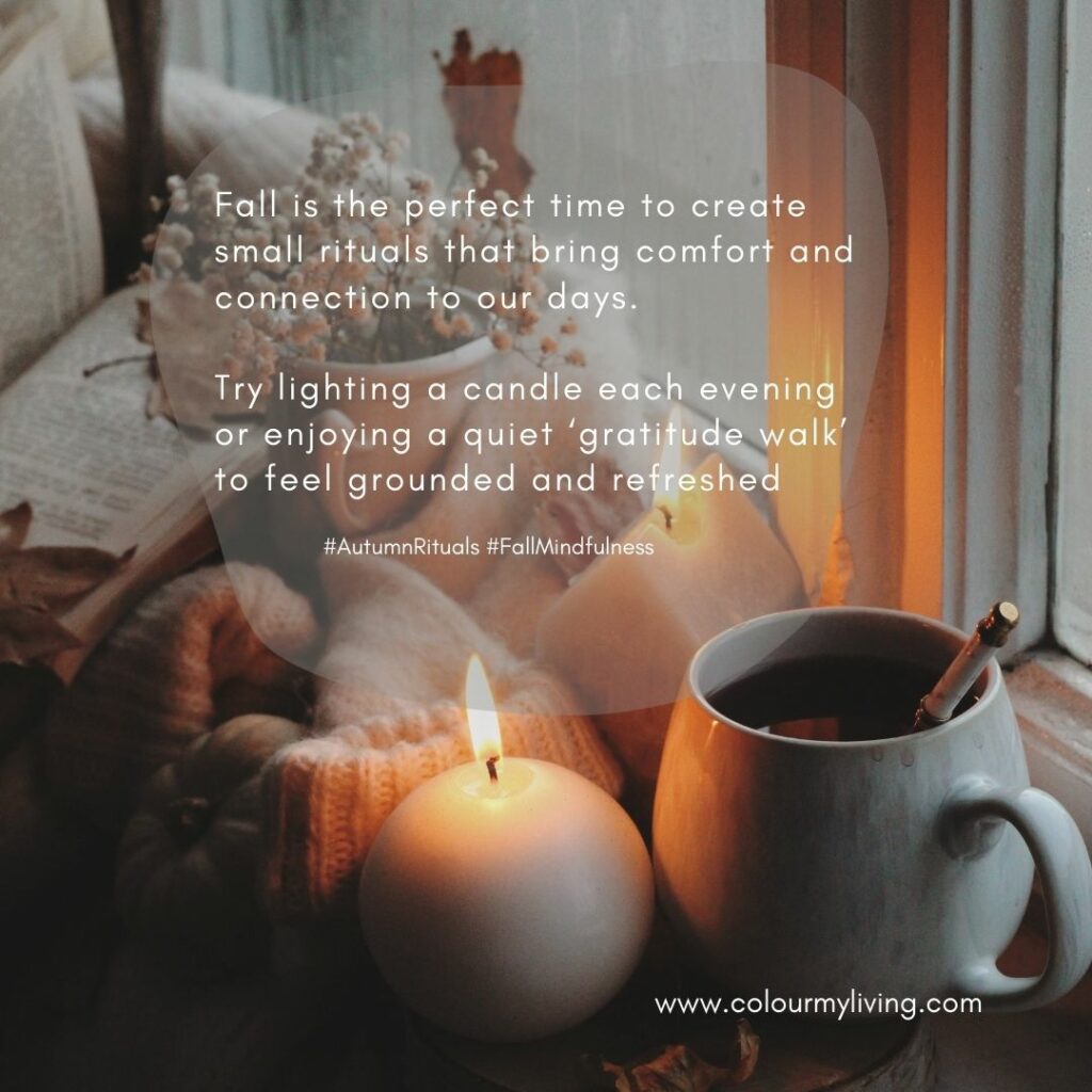 Image: A mug of a warm drink next to a round lit candle. in the background are woollen gloves, dried flowers in a small jar and an open book. Text: Fall is the perfect time to create small rituals that bring comfort and connection to our days. ✨ Try lighting a candle each evening or enjoying a quiet ‘gratitude walk’ to feel grounded and refreshed. #AutumnRituals #FallMindfulness