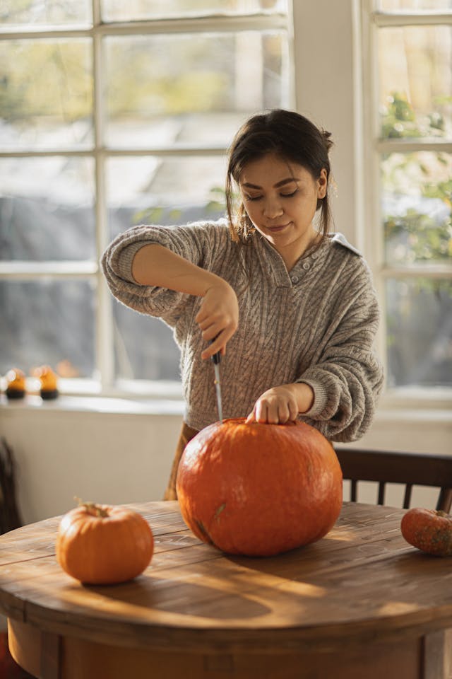 cutting pumpkin to make a vase