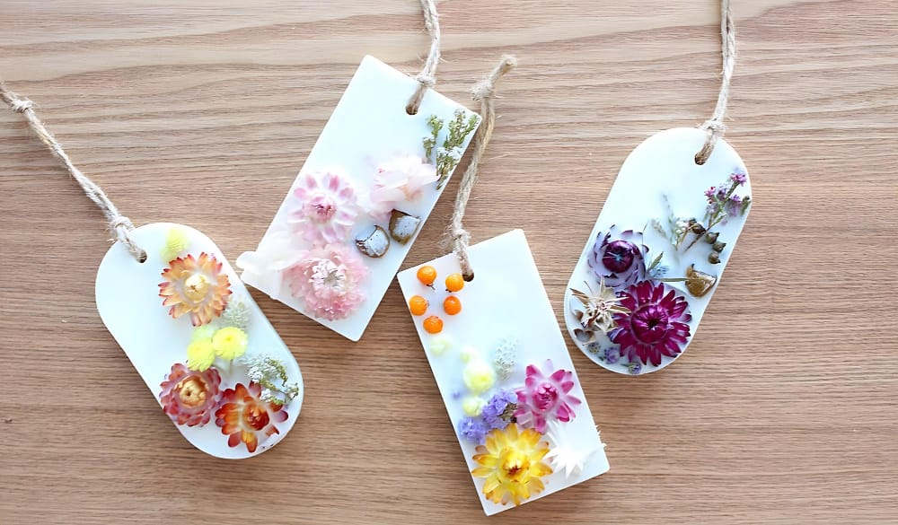 image shows four flower pressed book marks 